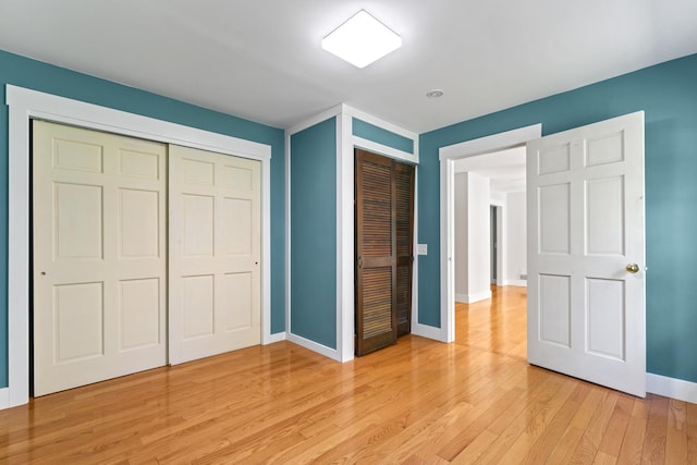 1046 N Riverside Dr, Momence, IL 60954 - unfurnished bedroom featuring light wood-style flooring and a closet