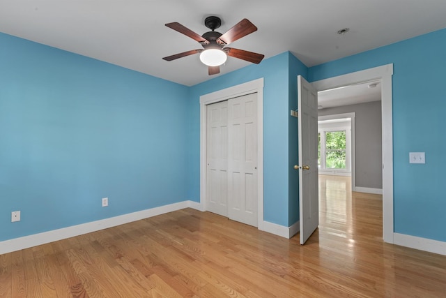 1046 N Riverside Dr, Momence, IL 60954 - unfurnished bedroom featuring light wood-style flooring, a closet, and a ceiling fan