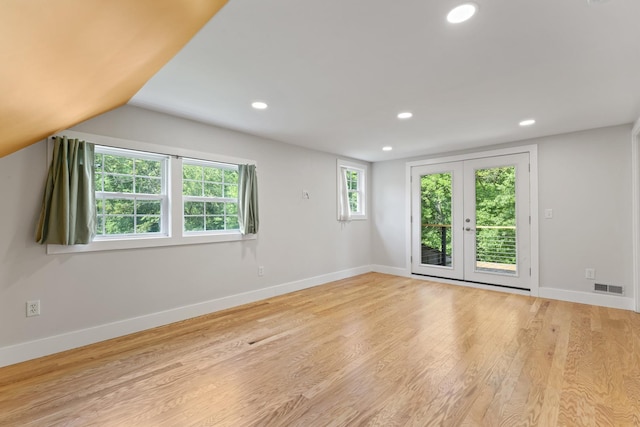1046 N Riverside Dr, Momence, IL 60954 - spare room with french doors, wood finished floors, recessed lighting, and vaulted ceiling