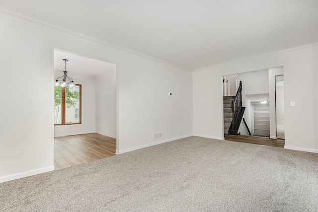 1500 Bunescu Ln, Buffalo Grove, IL 60089 - carpeted empty room featuring crown molding, baseboards, stairway, and a chandelier
