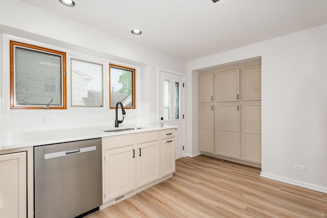 1500 Bunescu Ln, Buffalo Grove, IL 60089 - kitchen with dishwasher, a sink, light wood-style flooring, light countertops, and baseboards