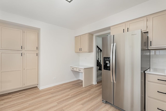1500 Bunescu Ln, Buffalo Grove, IL 60089 - kitchen featuring stainless steel fridge, cream cabinets, light wood-type flooring, light countertops, and baseboards