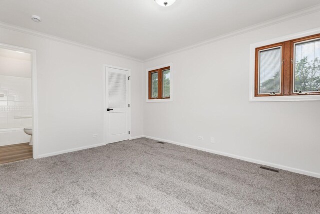 1500 Bunescu Ln, Buffalo Grove, IL 60089 - unfurnished bedroom featuring carpet, crown molding, baseboards, and connected bathroom