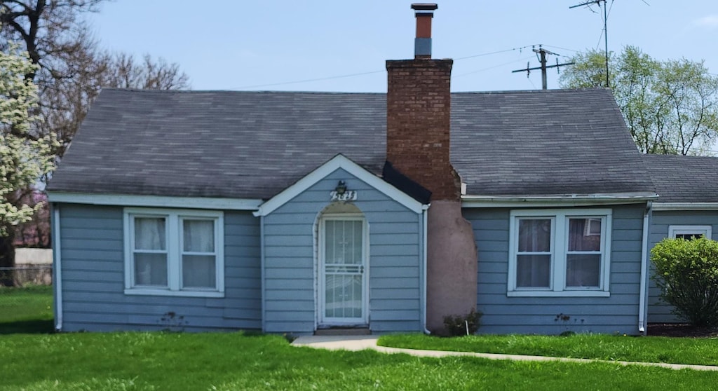 15825 Spaulding Ave, Markham, IL 60428 - rear view of house with a chimney and a lawn