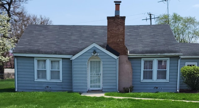 15825 Spaulding Ave, Markham, IL 60428 - rear view of house with a chimney and a lawn