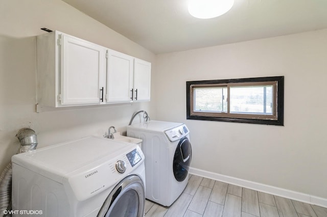 1678 Pratt Ave, Des Plaines, IL 60018 - laundry room featuring cabinet space, washer and dryer, baseboards, and wood tiled floors
