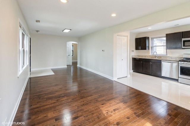 1678 Pratt Ave, Des Plaines, IL 60018 - kitchen with stainless steel appliances, arched walkways, hardwood / wood-style flooring, open floor plan, and baseboards