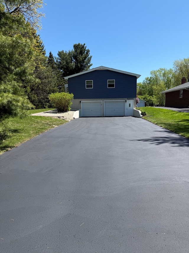 11 S Roberts Rd, Inverness, IL 60067 - view of front of property with an attached garage, driveway, and a front lawn