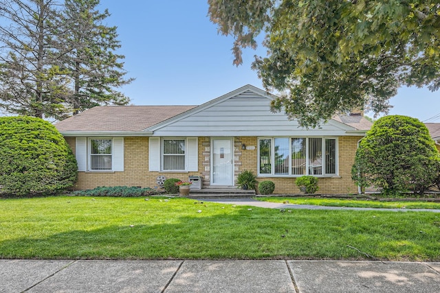 9001 Mobile Ave, Oak Lawn, IL 60453 - view of front of house with brick siding, a front lawn, and a chimney