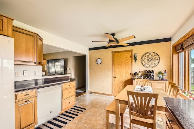 9001 Mobile Ave, Oak Lawn, IL 60453 - kitchen featuring white appliances, dark countertops, ceiling fan, light tile patterned floors, and brown cabinets