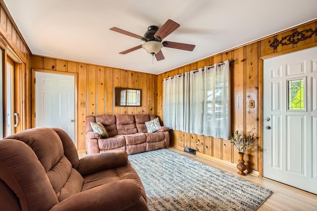 9001 Mobile Ave, Oak Lawn, IL 60453 - living area with a ceiling fan, wood walls, light wood-style floors, and plenty of natural light
