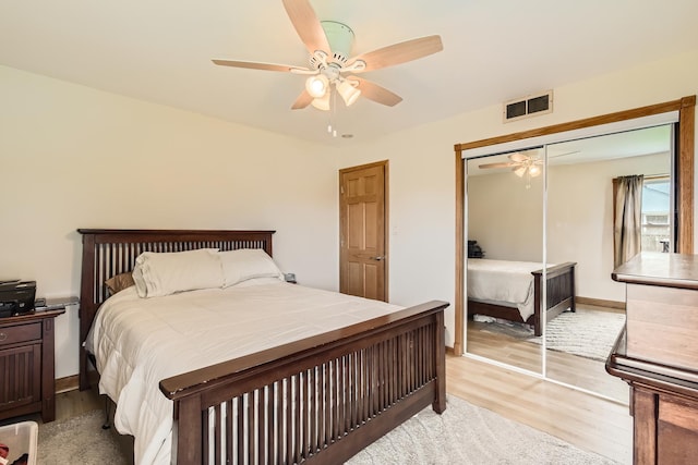 9001 Mobile Ave, Oak Lawn, IL 60453 - bedroom featuring light wood-style flooring, a closet, and a ceiling fan