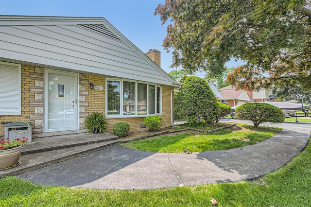 9001 Mobile Ave, Oak Lawn, IL 60453 - property entrance with a chimney and brick siding