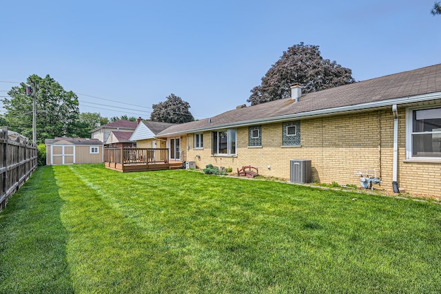 9001 Mobile Ave, Oak Lawn, IL 60453 - back of property featuring a wooden deck, a storage unit, and brick siding