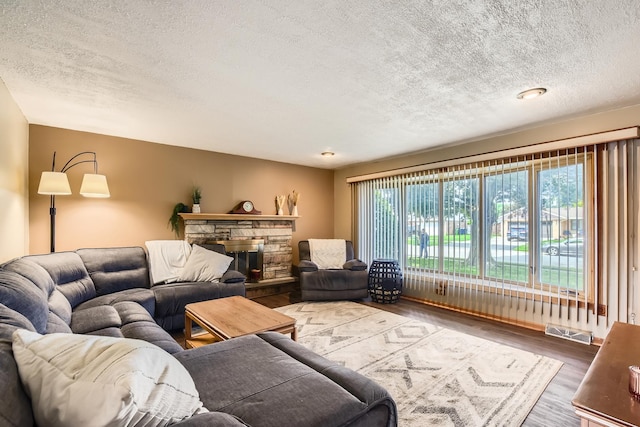 9001 Mobile Ave, Oak Lawn, IL 60453 - living area featuring a textured ceiling, wood finished floors, and a fireplace
