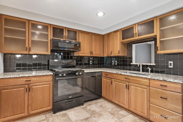 5502 Thelen Ave, Mchenry, IL 60050 - kitchen with black appliances, backsplash, light stone countertops, and glass insert cabinets