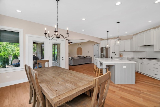20111 N Woodland Cir, Mokena, IL 60448 - dining area featuring healthy amount of natural light, light wood-style flooring, a chandelier, arched walkways, and recessed lighting