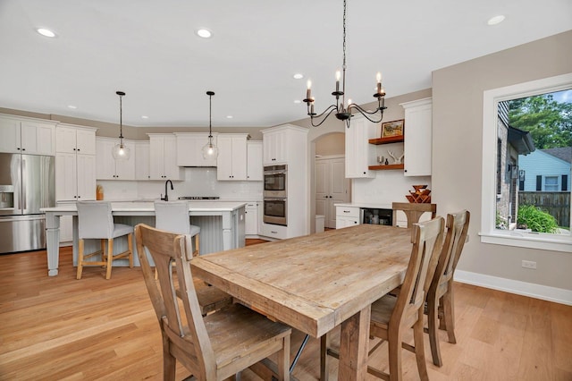 20111 N Woodland Cir, Mokena, IL 60448 - dining space with recessed lighting, light wood-style flooring, a chandelier, and arched walkways