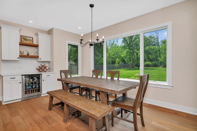 20111 N Woodland Cir, Mokena, IL 60448 - dining room with beverage cooler, healthy amount of natural light, light wood finished floors, a chandelier, and recessed lighting