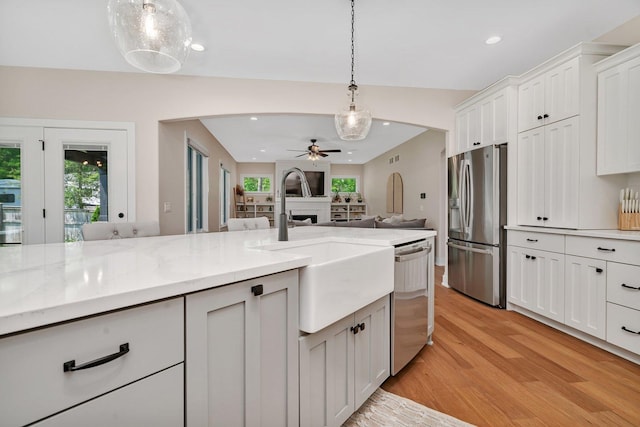 20111 N Woodland Cir, Mokena, IL 60448 - kitchen with stainless steel appliances, ceiling fan, light wood-type flooring, a fireplace, and recessed lighting