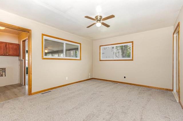 1220 Highland Ave, Lockport, IL 60441 - unfurnished room featuring light colored carpet, ceiling fan, and baseboards