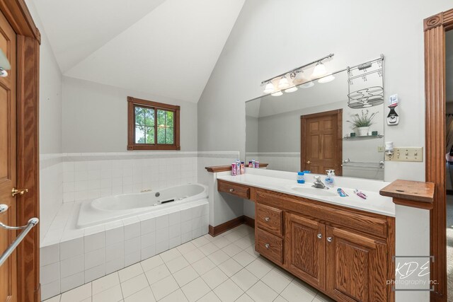 645 Saint Christopher Ct, Aurora, IL 60506 - bathroom featuring a bath, tile patterned floors, vanity, and vaulted ceiling