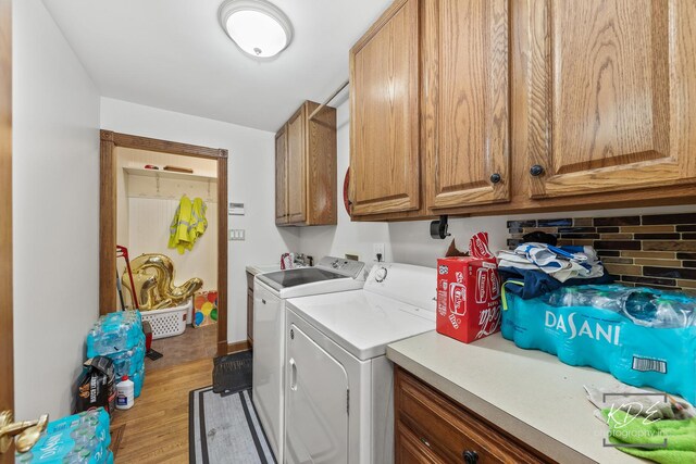 645 Saint Christopher Ct, Aurora, IL 60506 - laundry room with cabinet space, washer and clothes dryer, and wood finished floors