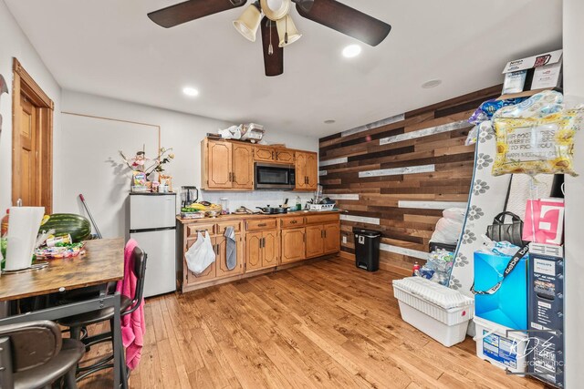 645 Saint Christopher Ct, Aurora, IL 60506 - kitchen with stainless steel appliances, a ceiling fan, light wood-style floors, wood walls, and recessed lighting