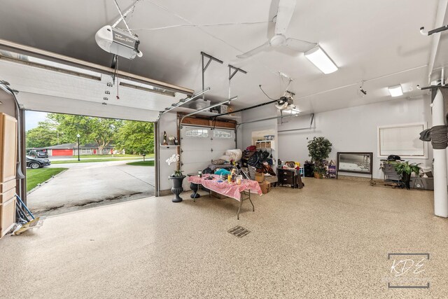 645 Saint Christopher Ct, Aurora, IL 60506 - garage with a garage door opener and a ceiling fan