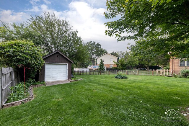 645 Saint Christopher Ct, Aurora, IL 60506 - fenced backyard featuring an outdoor structure and a garage