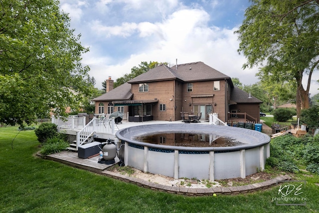 645 Saint Christopher Ct, Aurora, IL 60506 - back of property featuring a wooden deck, a covered pool, a yard, a chimney, and roof with shingles
