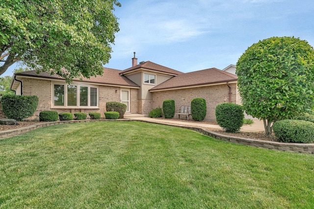 8932 Pebble Beach Ln, Orland Park, IL 60462 - view of front facade featuring brick siding, a front lawn, a chimney, and a shingled roof