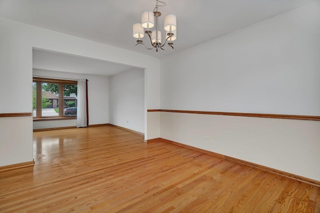 8932 Pebble Beach Ln, Orland Park, IL 60462 - empty room featuring a chandelier and light wood-type flooring