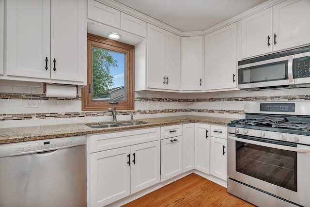 8932 Pebble Beach Ln, Orland Park, IL 60462 - kitchen featuring appliances with stainless steel finishes, white cabinets, backsplash, and light stone countertops
