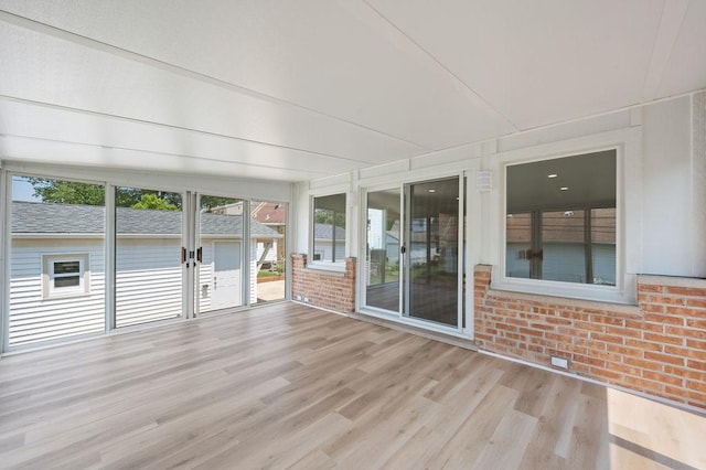 7810 N Neva Ave, Niles, IL 60714 - unfurnished sunroom featuring wood finished floors and brick wall