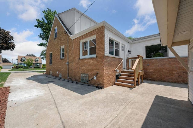 7810 N Neva Ave, Niles, IL 60714 - view of home's exterior featuring brick siding and board and batten siding