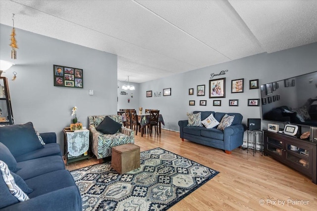 134 Klein Creek Ct Unit 4D, Carol Stream, IL 60188 - living area with light wood-style floors, a chandelier, a textured ceiling, and a baseboard heating unit