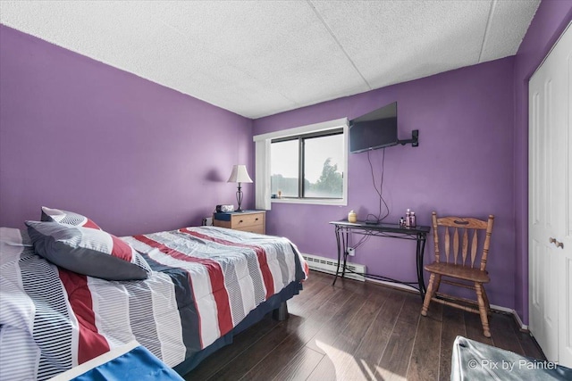 134 Klein Creek Ct Unit 4D, Carol Stream, IL 60188 - bedroom featuring a baseboard heating unit, wood finished floors, a textured ceiling, and a closet
