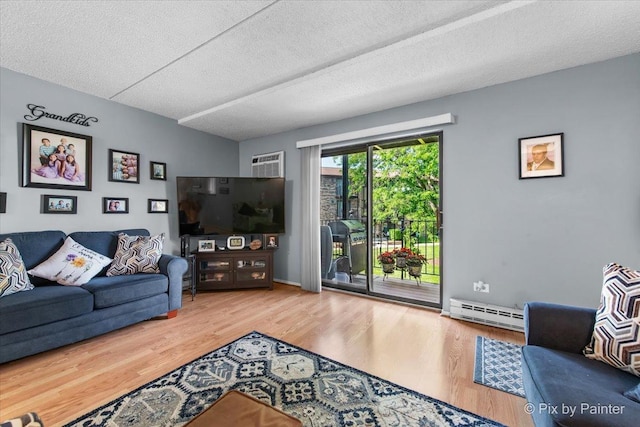 134 Klein Creek Ct Unit 4D, Carol Stream, IL 60188 - living area featuring a baseboard heating unit, wood finished floors, a textured ceiling, and an AC wall unit