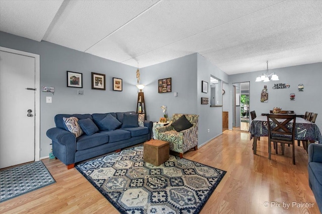 134 Klein Creek Ct Unit 4D, Carol Stream, IL 60188 - living area with light wood-type flooring, a chandelier, and a textured ceiling