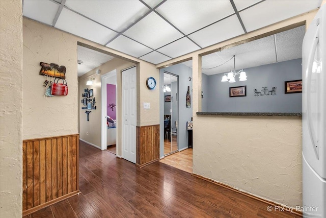 134 Klein Creek Ct Unit 4D, Carol Stream, IL 60188 - spare room featuring wood-type flooring, a drop ceiling, a wainscoted wall, wooden walls, and a textured wall
