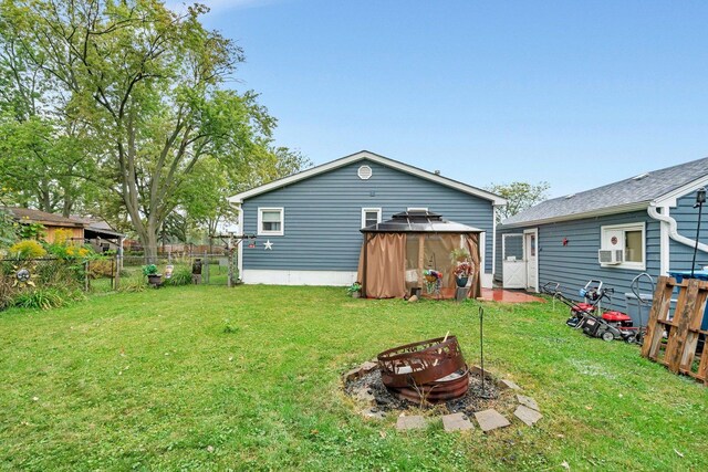 5203 W Court St, Monee, IL 60449 - rear view of house featuring a fire pit and a gazebo