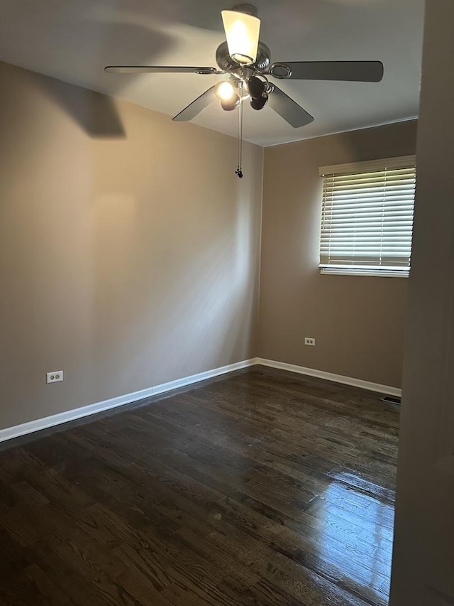 19205 Ada St, Lansing, IL 60438 - empty room with a ceiling fan and dark wood-style flooring