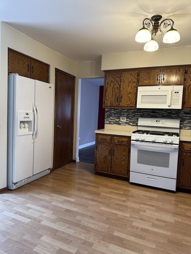 19205 Ada St, Lansing, IL 60438 - kitchen featuring white appliances, decorative backsplash, light wood finished floors, light countertops, and baseboards