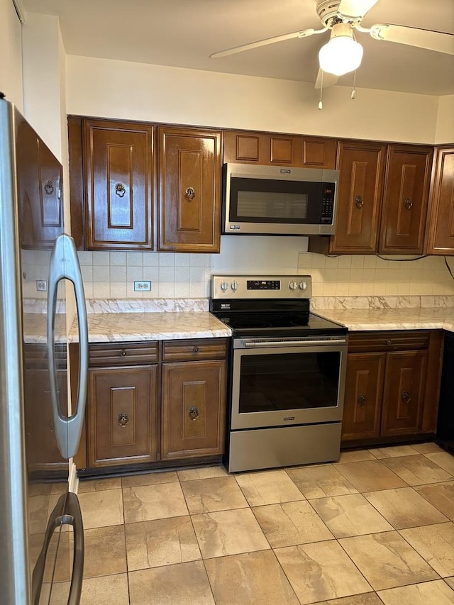 6007 N Sheridan Rd Unit 24H, Chicago, IL 60660 - kitchen with appliances with stainless steel finishes, light countertops, decorative backsplash, and dark brown cabinets