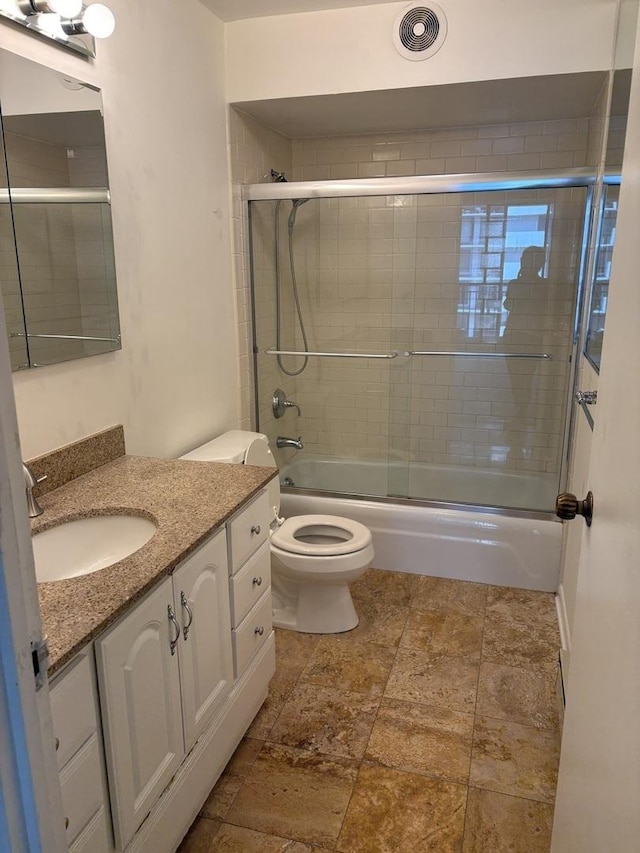 6007 N Sheridan Rd Unit 24H, Chicago, IL 60660 - full bathroom featuring vanity, stone tile flooring, and combined bath / shower with glass door