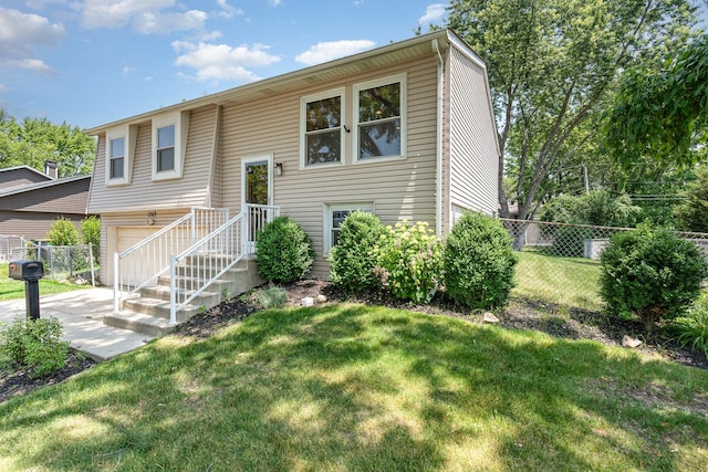 1262 N Kennedy Dr, Streamwood, IL 60107 - raised ranch with a garage and a patio area