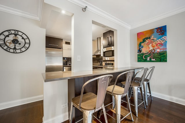 200 N Dearborn St Unit 2006, Chicago, IL 60601 - kitchen featuring stainless steel appliances, a breakfast bar area, modern cabinets, dark wood finished floors, and ornamental molding