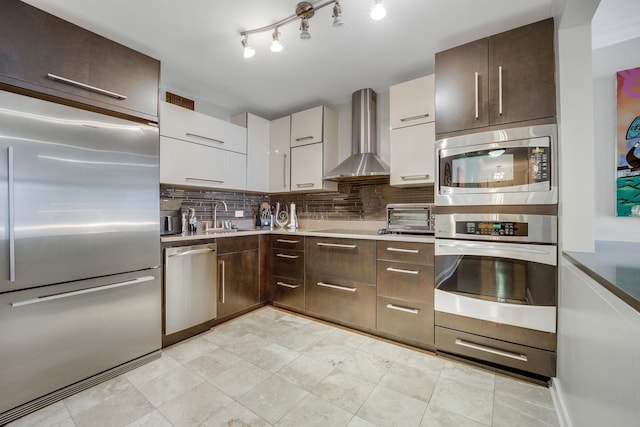 200 N Dearborn St Unit 2006, Chicago, IL 60601 - kitchen with built in appliances, wall chimney exhaust hood, dark brown cabinetry, backsplash, and modern cabinets