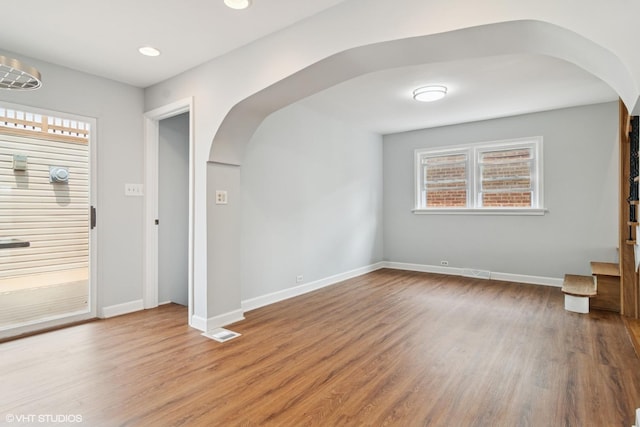 7032 W 63rd Pl, Chicago, IL 60638 - empty room featuring arched walkways, plenty of natural light, wood finished floors, and recessed lighting